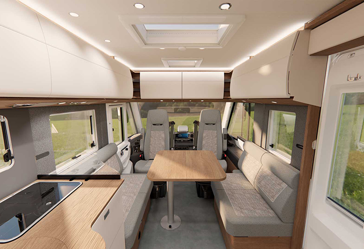 Carthago C2-Tourer 2027 model interior with face-to-face lounge seating, wooden table and skylight