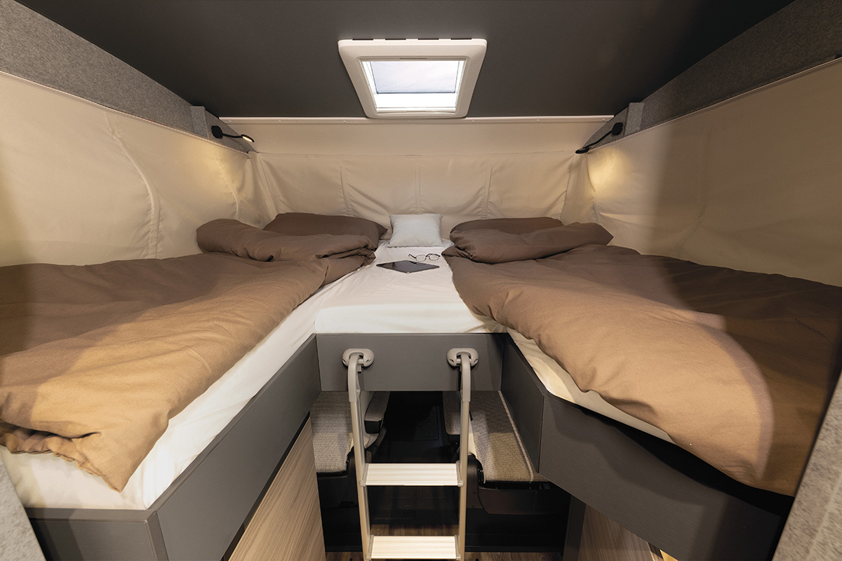 Dethleffs Trend I 7027 drop-down bed with single beds, reading lights and skylight above a ladder