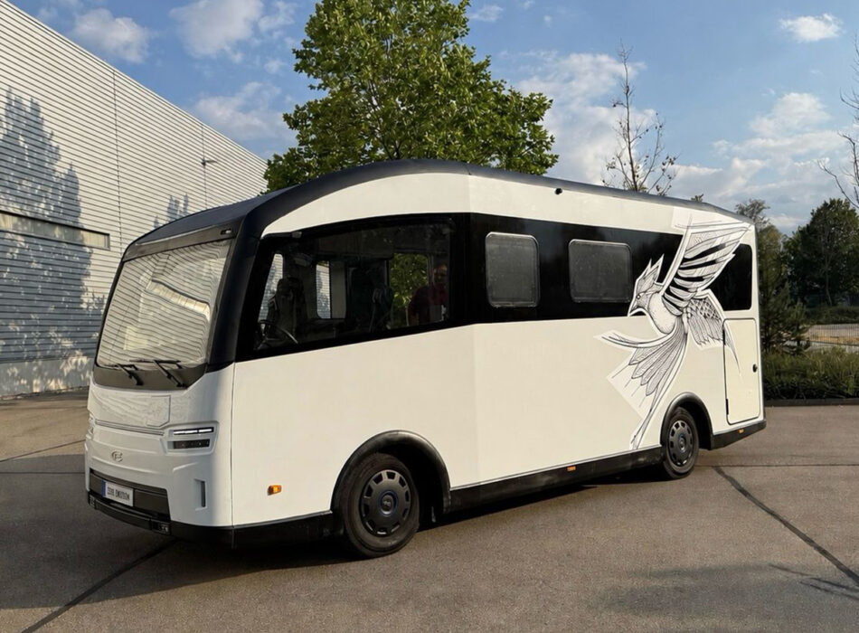 Electric Vöhringer CityFreighter campervan with bird graphic, parked outside on EV chassis