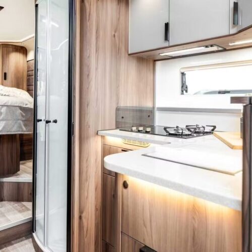 Kabe Imperial 4x4 motorhome interior showing kitchen with hob, sink and view through to bedroom and shower cubicle