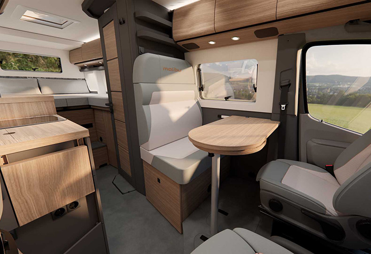 Malibu Genius 2027 campervan interior with swivel seat, wooden table and kitchenette – Malibu Camping Guide