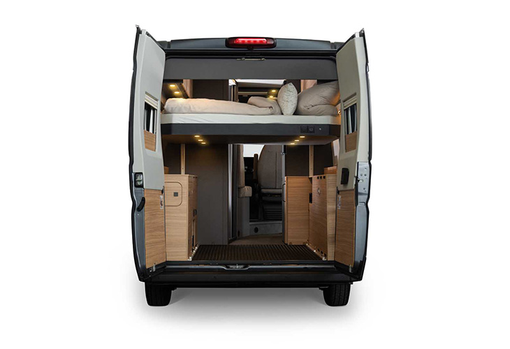 Malibu Relax 640 LE XR rear view showing raised adjustable bed and wooden storage cabinets, camper van interior.