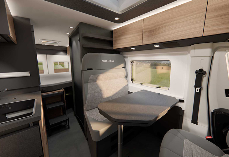 Malibu 640 LE XR seating area with dining table and window, featured in the Malibu Camping Guide
