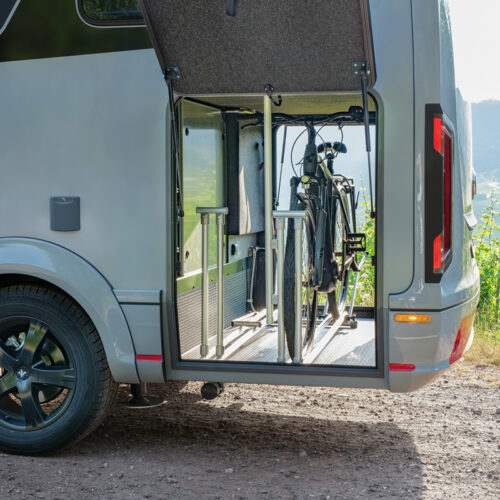 Niesmann+Bischoff iSmove 2027 motorhome with open garage door revealing bicycle storage compartment