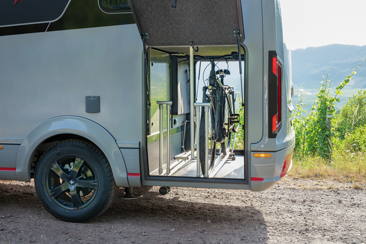 Niesmann+Bischoff iSmove 2027 motorhome with open garage door revealing bicycle storage compartment