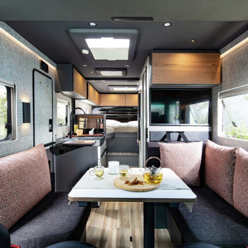 Niesmann+Bischoff iSmove 2027 interior with dinette seating, kitchenette, TV and skylight in campervan