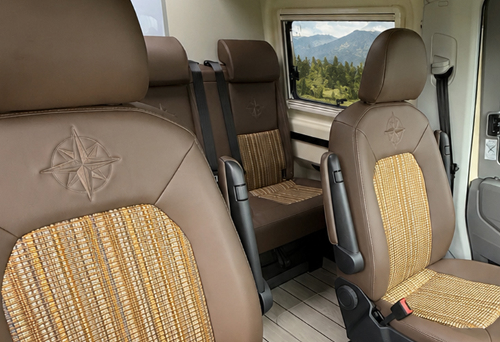 Westfalia Sven Hedin Anniversary Edition interior with brown leather seats, compass emblem, and woven bamboo inserts.