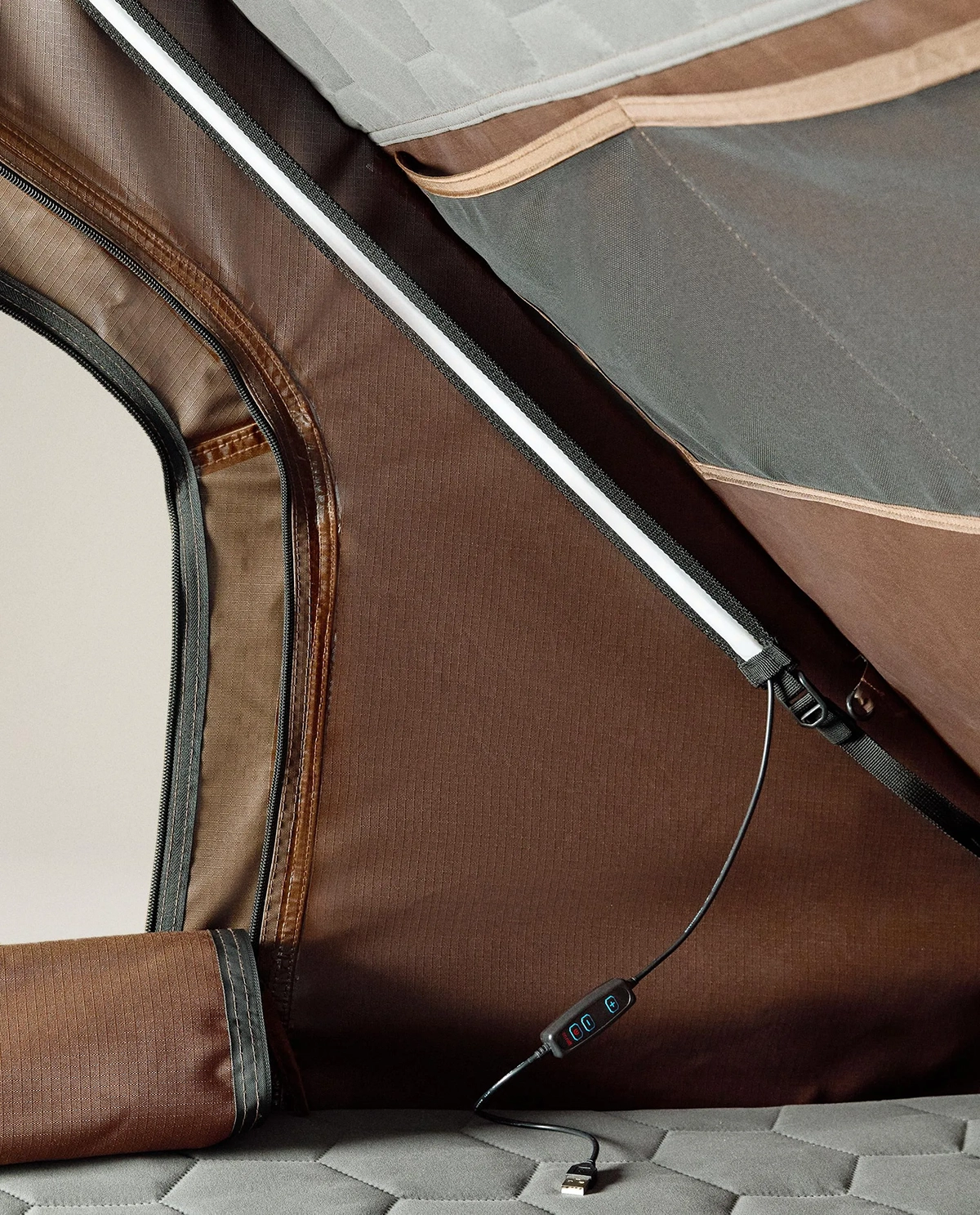 Interior view of the Zara Home rooftop tent with LED light strip, USB control panel and zipped mesh window.