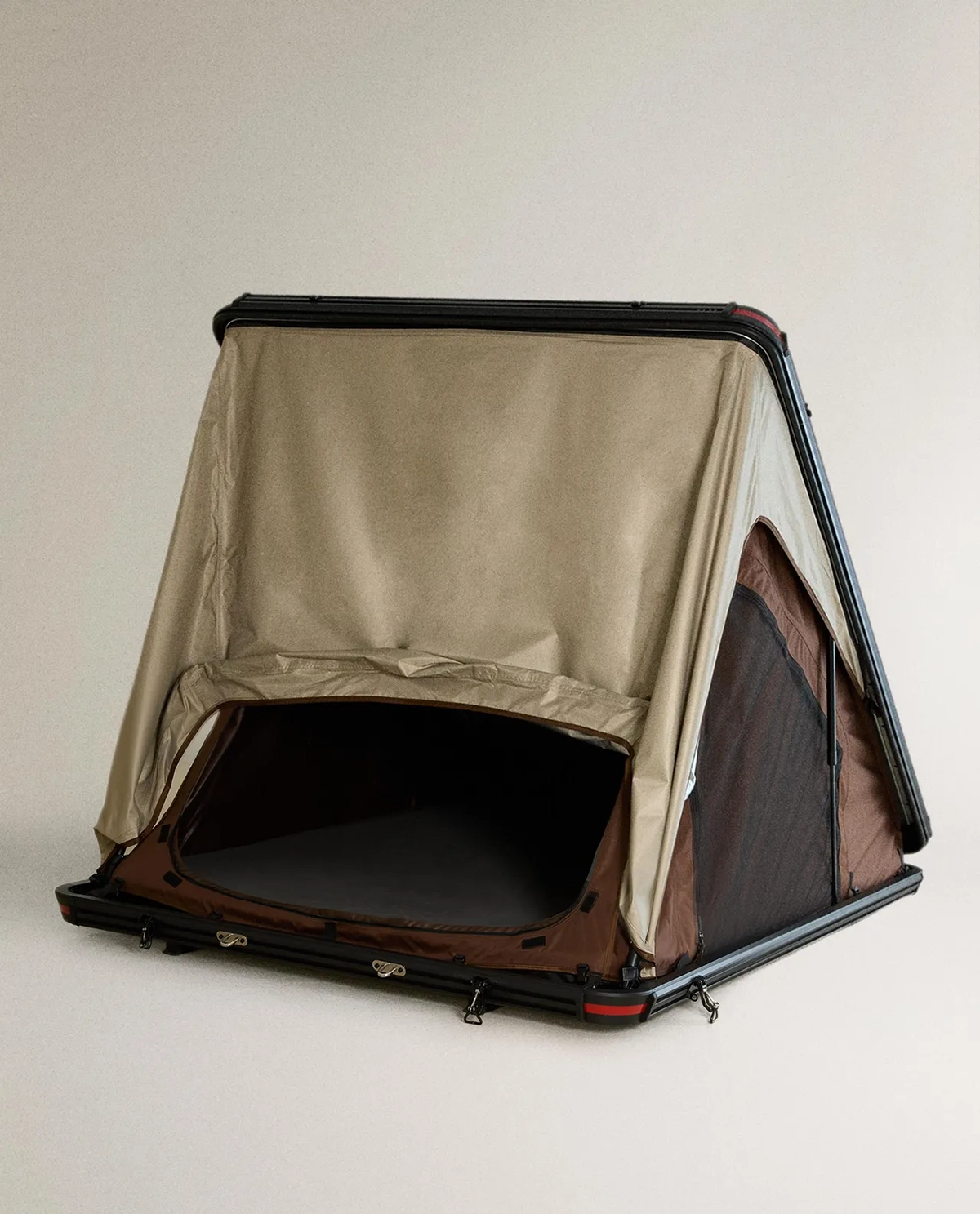 Zara Home rooftop tent with hard-shell base, triangular frame and open beige and brown canvas doorway.