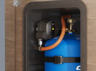 Truma MonoControl CS R crash sensor fitted to blue Campingaz cylinder in caravan storage locker
