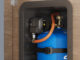 Truma MonoControl CS R crash sensor fitted to blue Campingaz cylinder in caravan storage locker