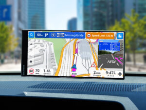 Garmin Drive navigation device mounted on car dashboard showing turn-by-turn directions towards A115 Messegelände