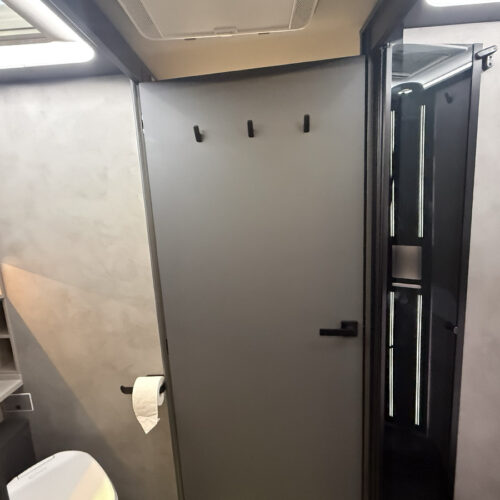 Frankia Noctra Liner bathroom with grey walls, toilet, mirror and separate shower cubicle