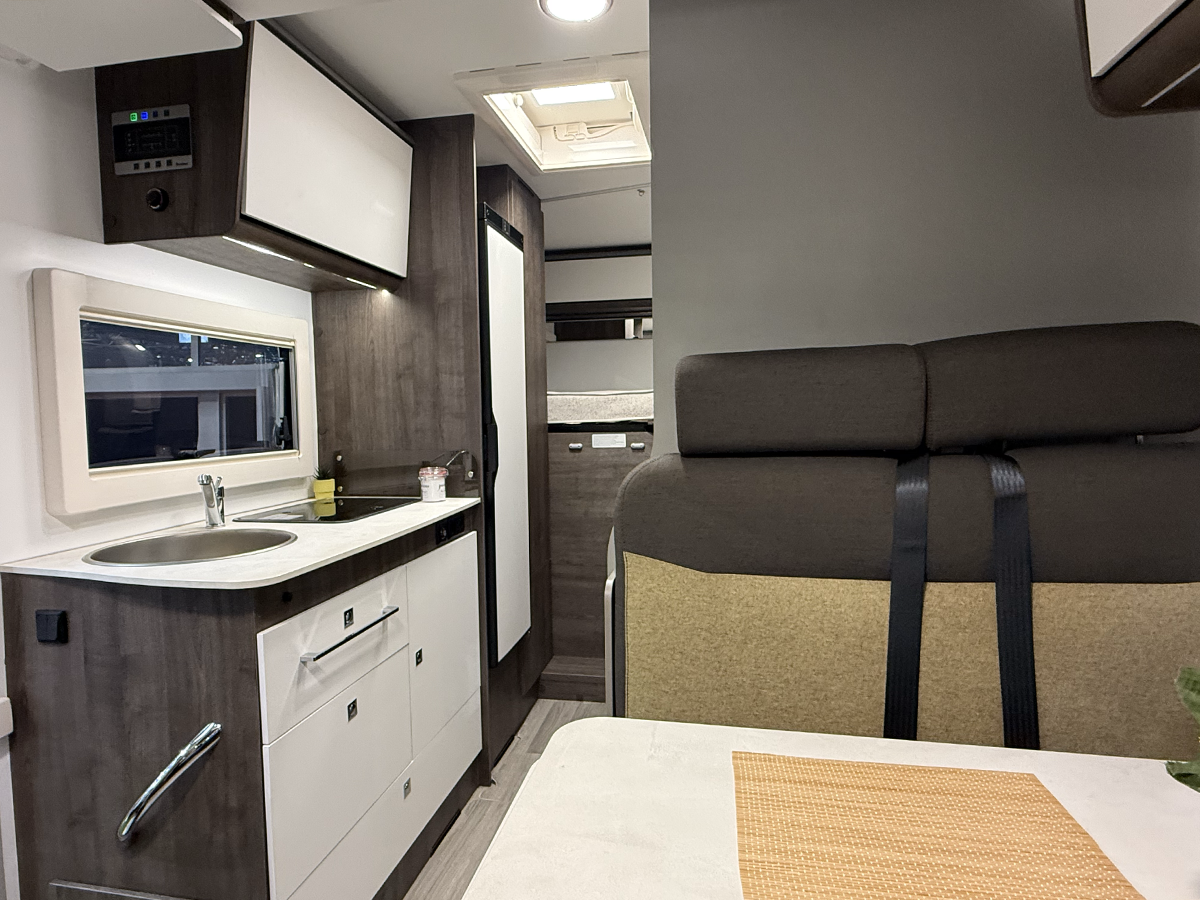 Benimar Kaleo K640 motorhome interior with kitchenette, sink, wardrobe and seating with seatbelts