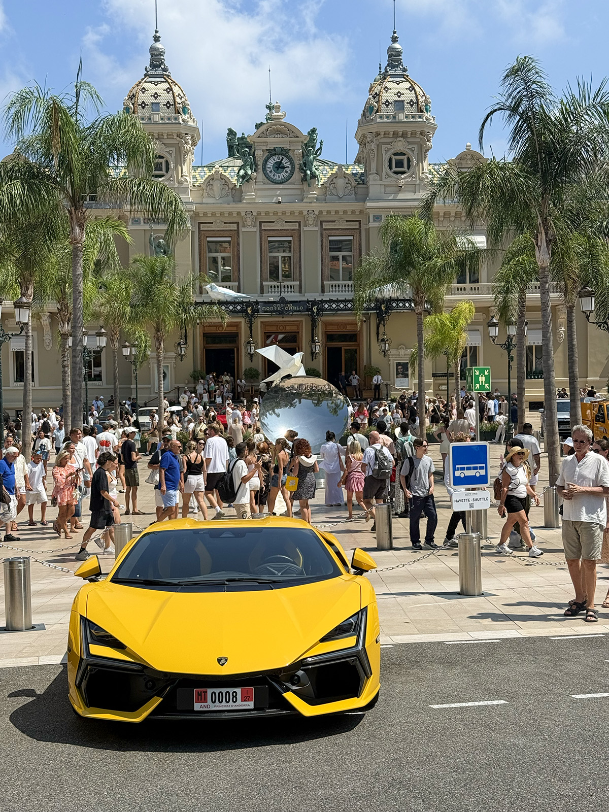 Yellow Lamborghini outside Monte Carlo Casino, a day trip highlight from camping Parc Bellevue Cannes