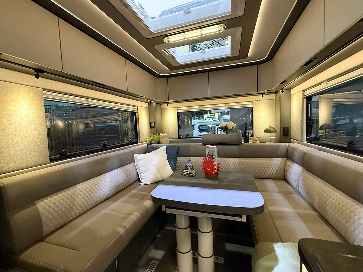 Dethleffs Graneo motorhome interior with U-shaped lounge seating, dining table and twin skylights
