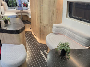 Toyota Innova Road Trip campervan interior showing lounge bench seating, wood cabinetry and compact kitchenette