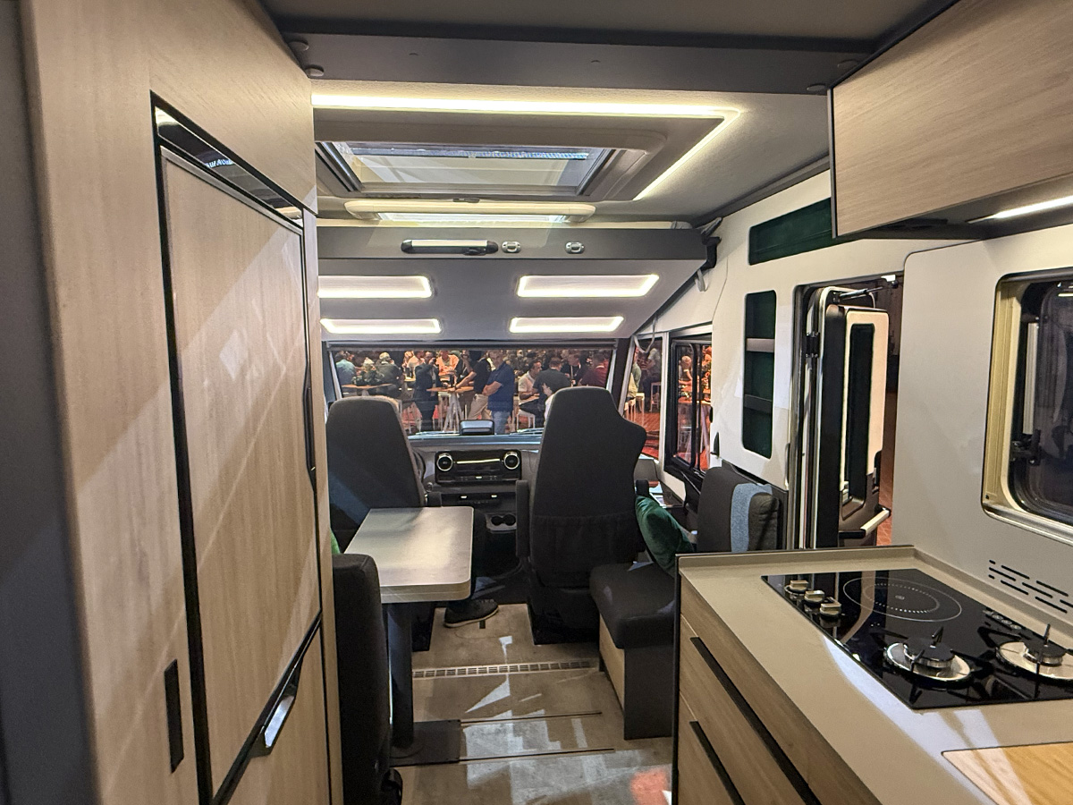 Frankia Noctra Liner motorhome interior showing cockpit, seating and kitchenette with cooktop at trade show
