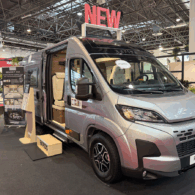 Rapido V64 camper van exterior on show floor, silver Fiat Ducato base with sliding door open, showing interior