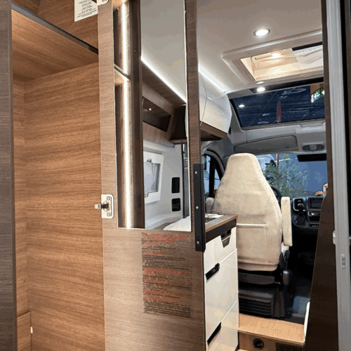 Rapido V64 wardrobe interior with mirror, showing view through to cab and driver's seat