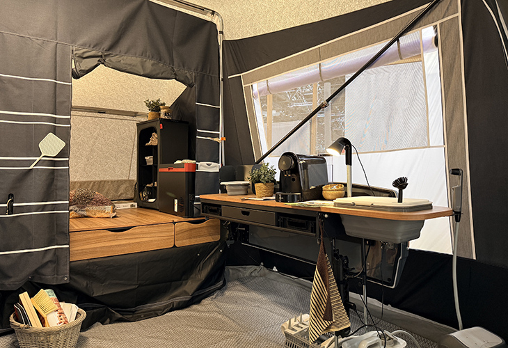 Camp-let Alba tent trailer interior with wooden worktop, sink, coffee machine and storage cabinet