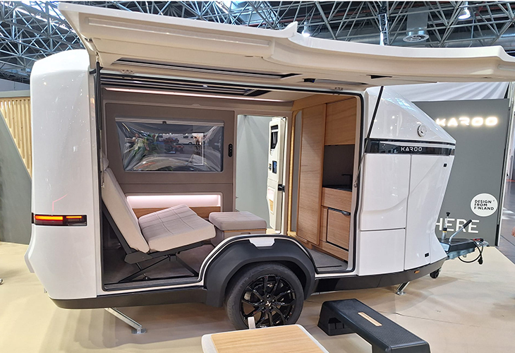 Karoo eye-catching compact caravan with open sides showing wooden kitchen and fold-out seating at Caravan Salon
