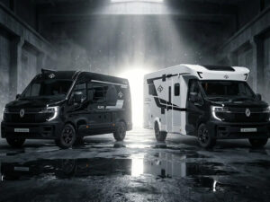 Ahorn Camp Eclipse Edition motorhomes in matte black and white, parked in dramatic lit warehouse setting