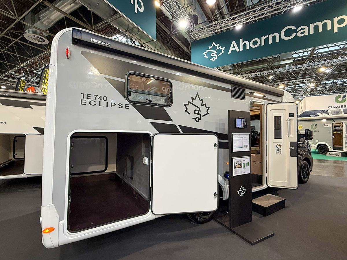 Ahorn Camp Eclipse TE 740 motorhome exterior at trade show, showing side storage locker and entry door open