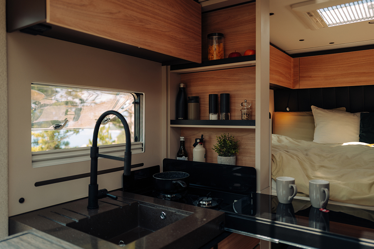 Bürstner Signature Mercedes motorhome kitchen with sink, hob and view through to bedroom area