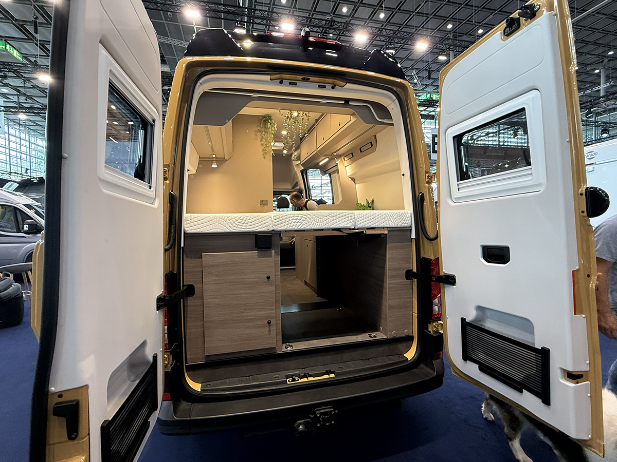 Rear view of the Carado CV595 X-Edition campervan with open back doors showing bed and storage compartment.