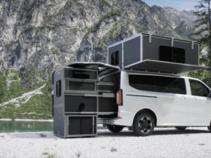 Cubivan camper van with pop-up rooftop tent and rear pull-out kitchen module, parked by mountain lake