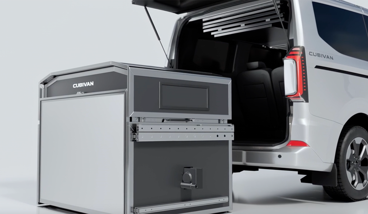 Cubivan modular camper box unit beside a white van with open rear doors, shown in folded configuration.