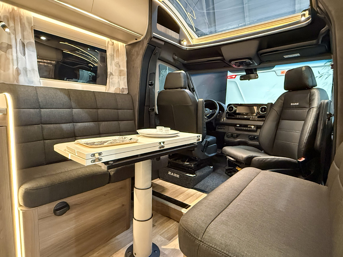 Kabe Novum Compact 720 LXL interior with swivel cab seats, dinette table and leather upholstery