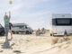 Hobby Aura caravan and motorhome parked on sandy beach with people relaxing and playing with a ball